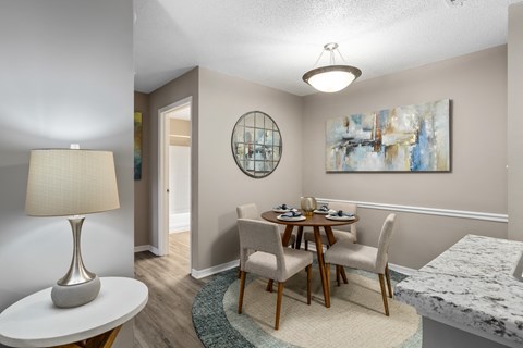 a dining room with a table and chairs