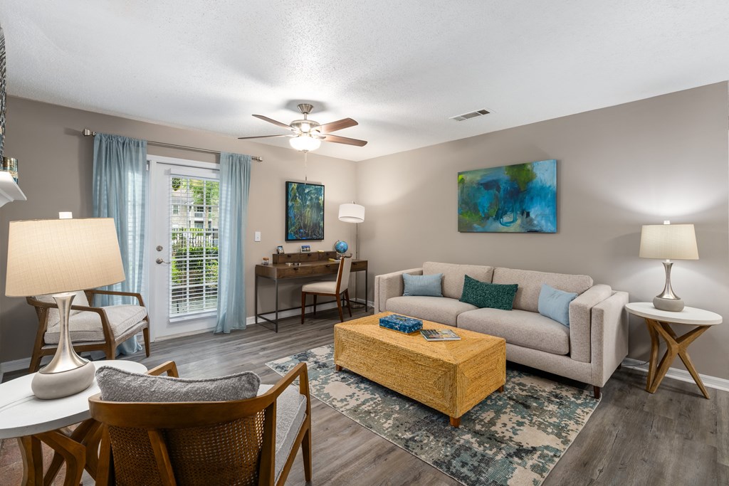 a living room with a couch coffee table and a ceiling fan