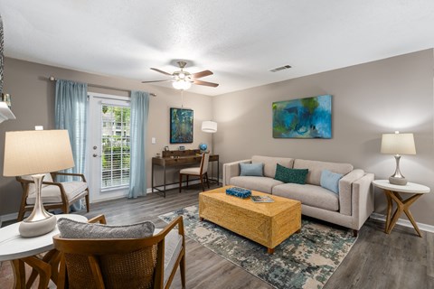 a living room with a couch coffee table and a ceiling fan