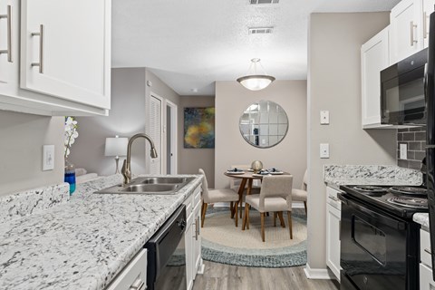 a kitchen and dining area in a 555 waverly unit