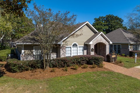 the front of a house with a lawn and a driveway
