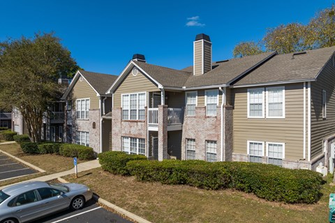 an apartment building with a car parked in front of it
