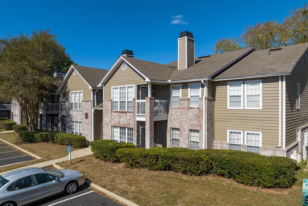 an apartment building with a car parked in front of it