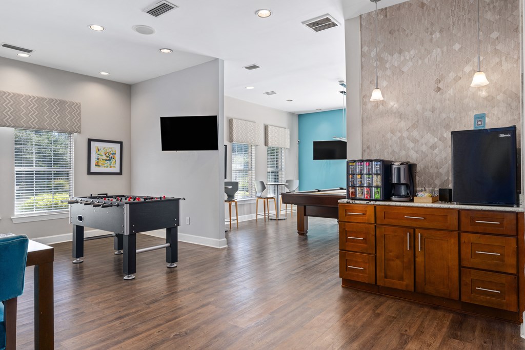 a game room with a pool table and a tv