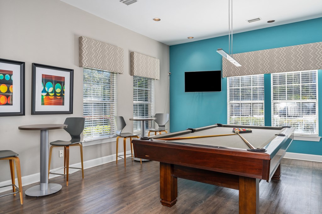 a game room with a pool table and a tv