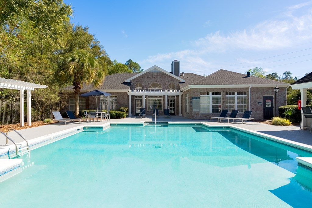 a swimming pool with a house in the background