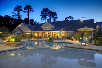 Resident clubhouse and swimming pool at night at Lullwater at Blair Stone - Photo Gallery 6