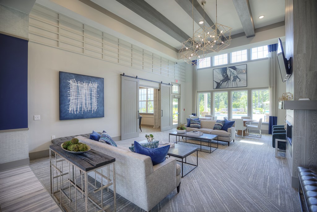 Resident clubhouse with couches and TV at Lullwater at Blair Stone apartments for rent