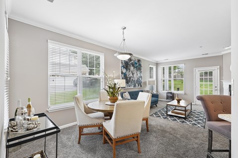 A dining room with a glass table and chairs.