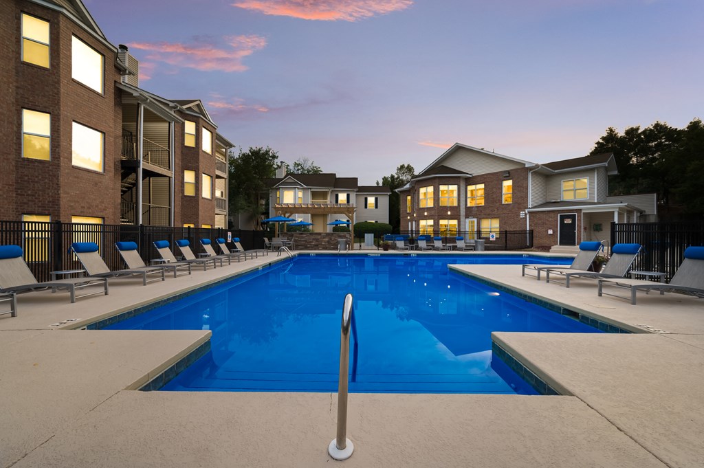 Outdoor resort-style swimming pool with lounge chairs at Chace Lake Villas apartments in Birmingham, AL