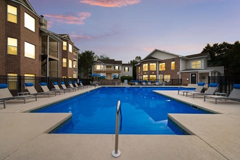 Outdoor resort-style swimming pool with lounge chairs at Chace Lake Villas apartments in Birmingham, AL