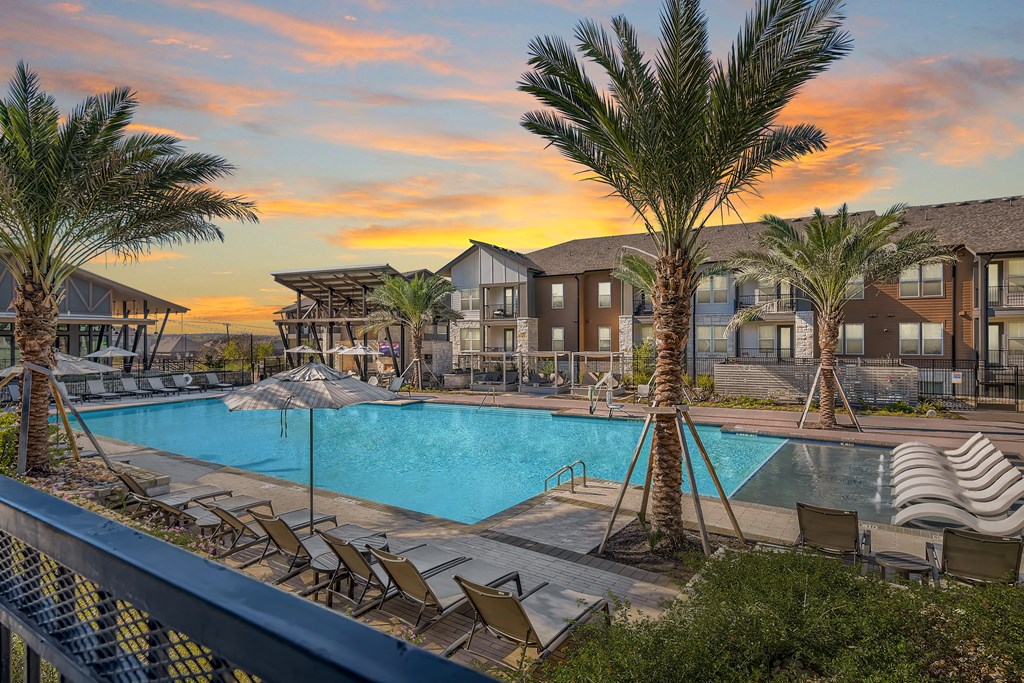Cypress McKinney Falls resort-style swimming pool with large sundeck at sunset in Austin, TX
