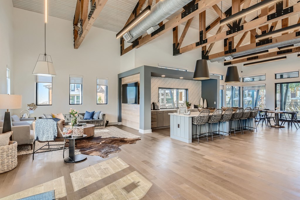 Resident clubhouse with cozy seating, communal kitchen and bar at Cypress McKinney Falls in Austin, TX