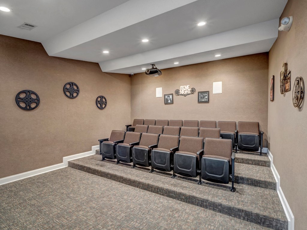 a large room with a large carpeted floor and a row of chairs with wheels on the