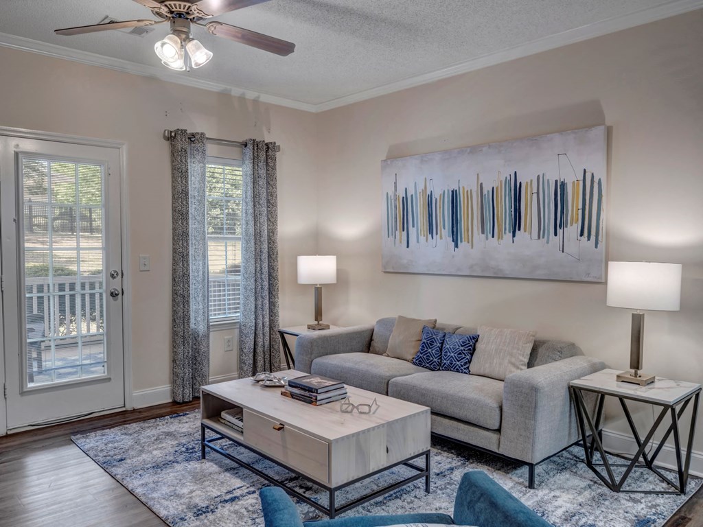 a living room with a couch coffee table and a ceiling fan