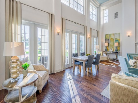 a living room and dining room with a table and chairs