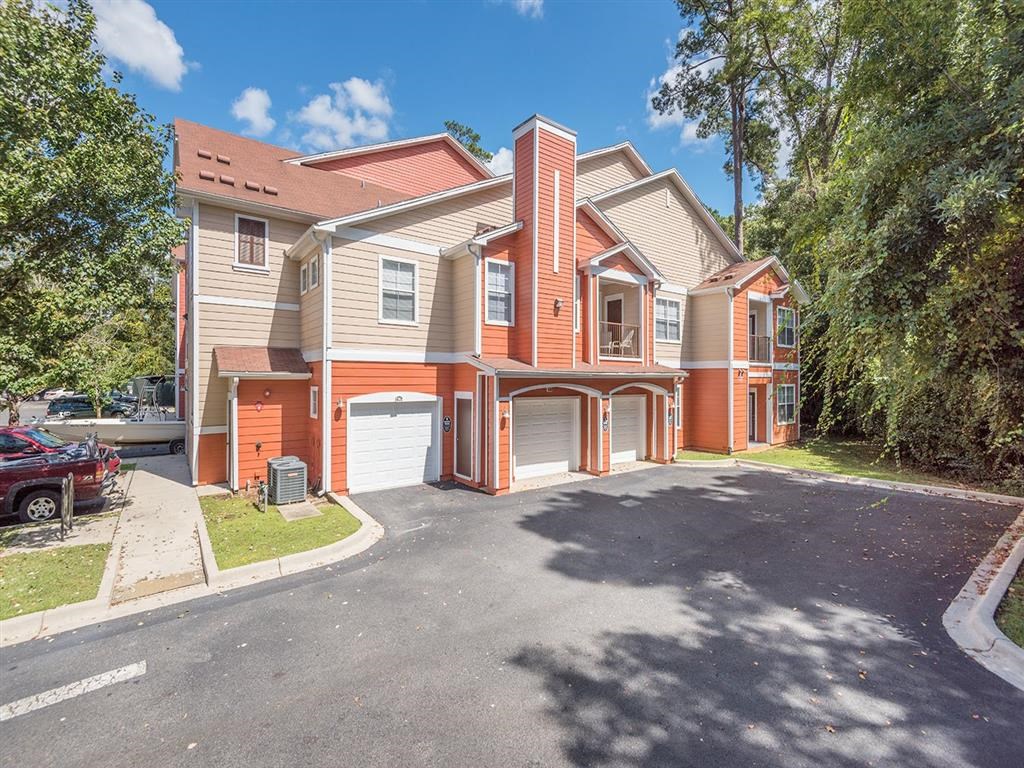 Residential buildings with private garage entrances at Evergreens at Mahan apartments in Tallahassee, FL