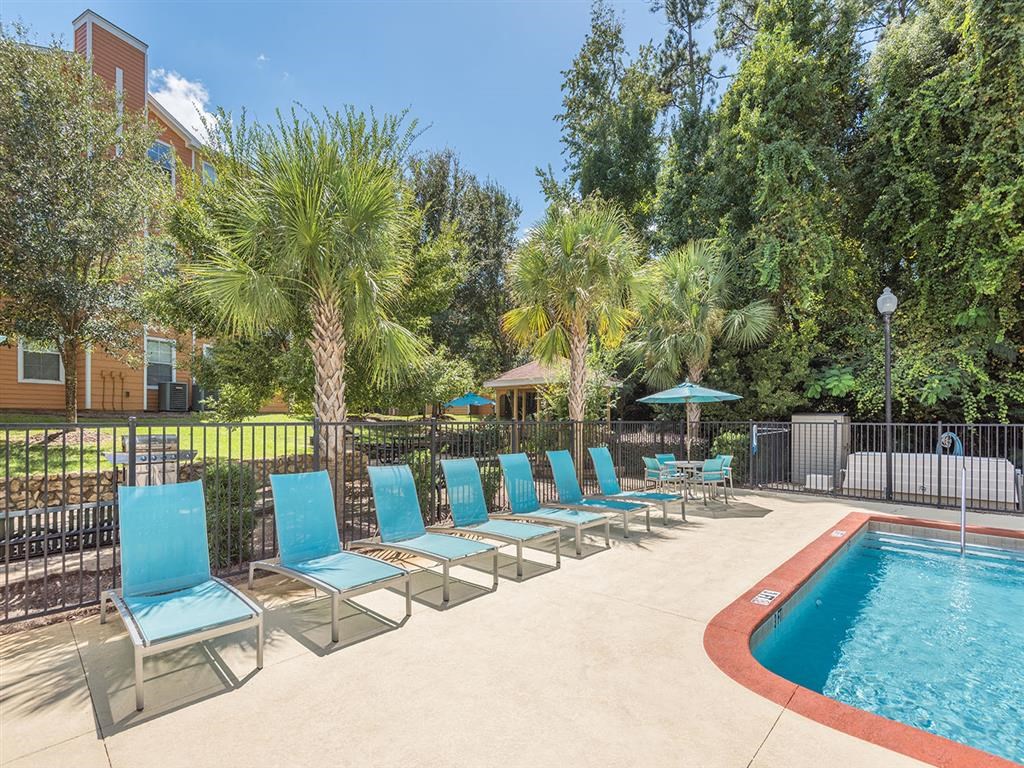 Tallahassee, FL apartment complex resort-style swimming pool with spa and lounge chairs at Evergreens at Mahan