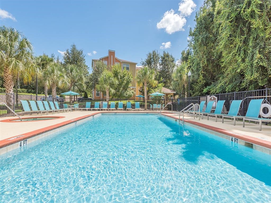 Tallahassee, FL apartment complex sparkling resort-style swimming pool and hot tub with lounge chairs at Evergreens at Mahan Tallahassee, FL apartment complex sparkling resort-style swimming pool and hot tub with lounge chairs at Evergreens at Mahan