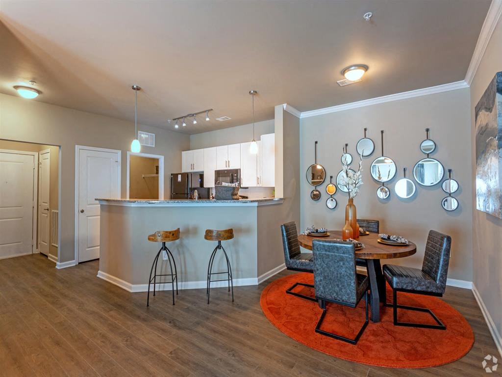 Kitchen with granite countertops and breakfast bar with view of dining area at Lullwater at Blair Stone apartments for rent