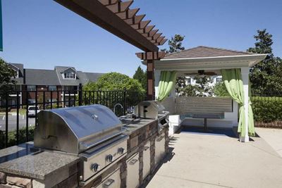 Resident grilling station with 2 BBQ grills and a sink in between at TEN35 Alexander Apartments