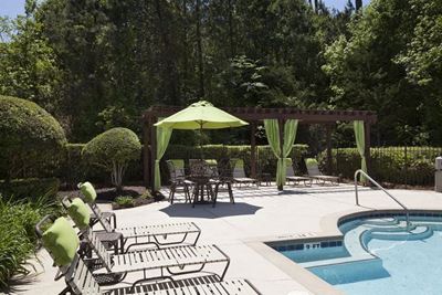 Pool pavilion with sundeck lounge chairs and umbrellas at TEN35 Alexander in Augusta, GA