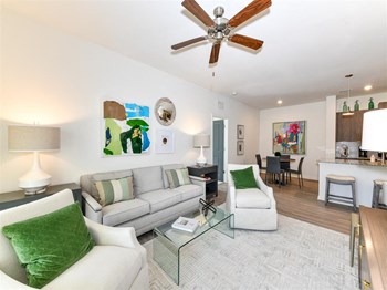 Open-concept living room with kitchen and dining area view at The Station at Brighton in Grovetown, GA