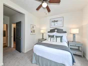 Carpeted bedroom with ceiling fan at The Station at Brighton in Grovetown, GA