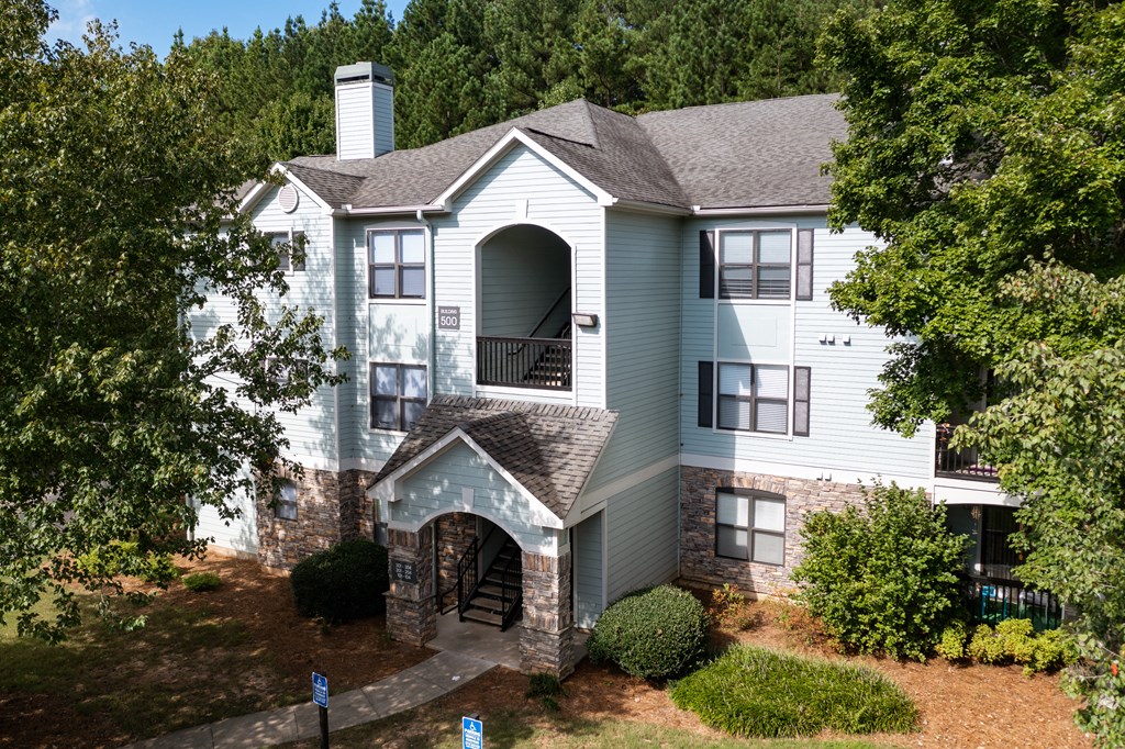 Three-story blue and stone residential building at Heritage at Riverstone in Canton, GA