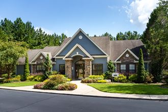 Exterior of the Heritage at Riverstone leasing office and clubhouse with lush landscaping in Canton, GA - Photo Gallery