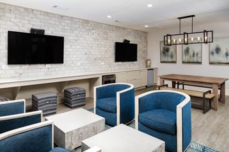 Resident clubhouse lounge with large TVS and various seating at Heritage at Riverstone in Canton, GA - Photo Gallery
