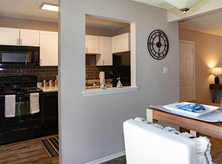 Kitchen and dining area with through window at Forest Ridge