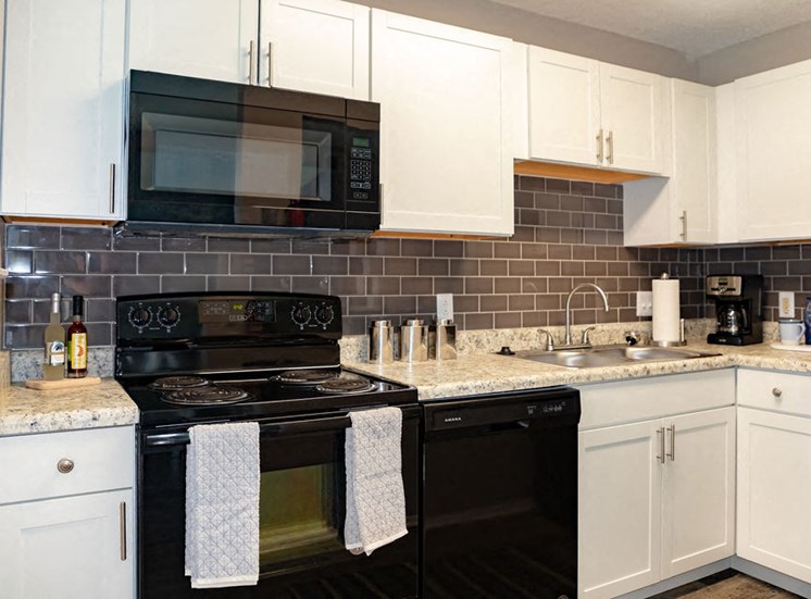 Kitchen with white cabinetry in Noth Macon apartment at Forest Ridge
