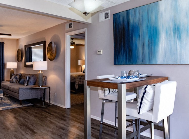 Living room and dining area in Macon apartment at Forest Ridge
