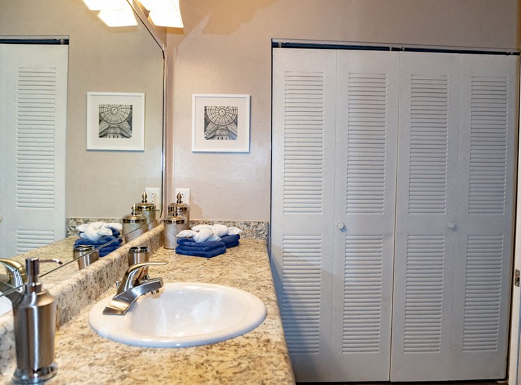 Bathroom sink and closet doors in Macon apartment