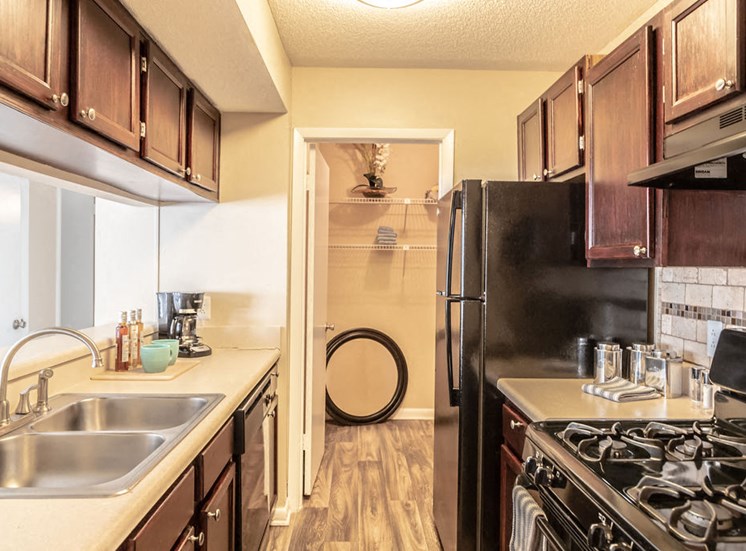 Kitchen with black appliances in Macon apartment