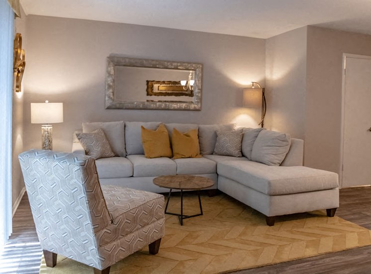 apartment living room with gray furniture and yellow carpet