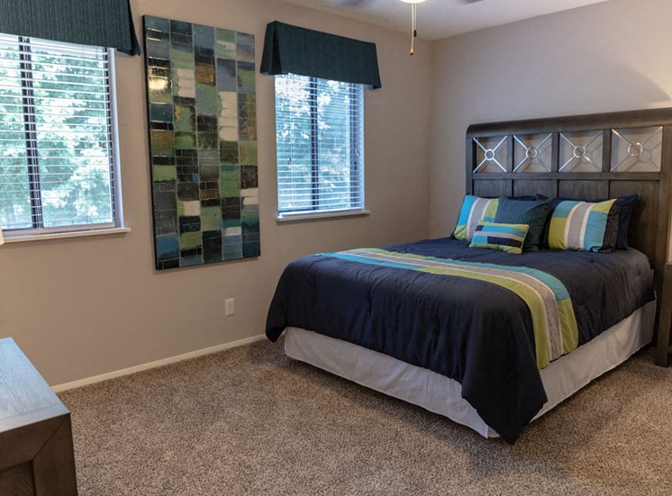 spacious apartment bedroom with two windows at Magnolia Crossing apartments
