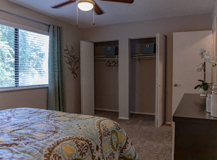 Macon apartment bedroom with ceiling fan and two closets with open doors