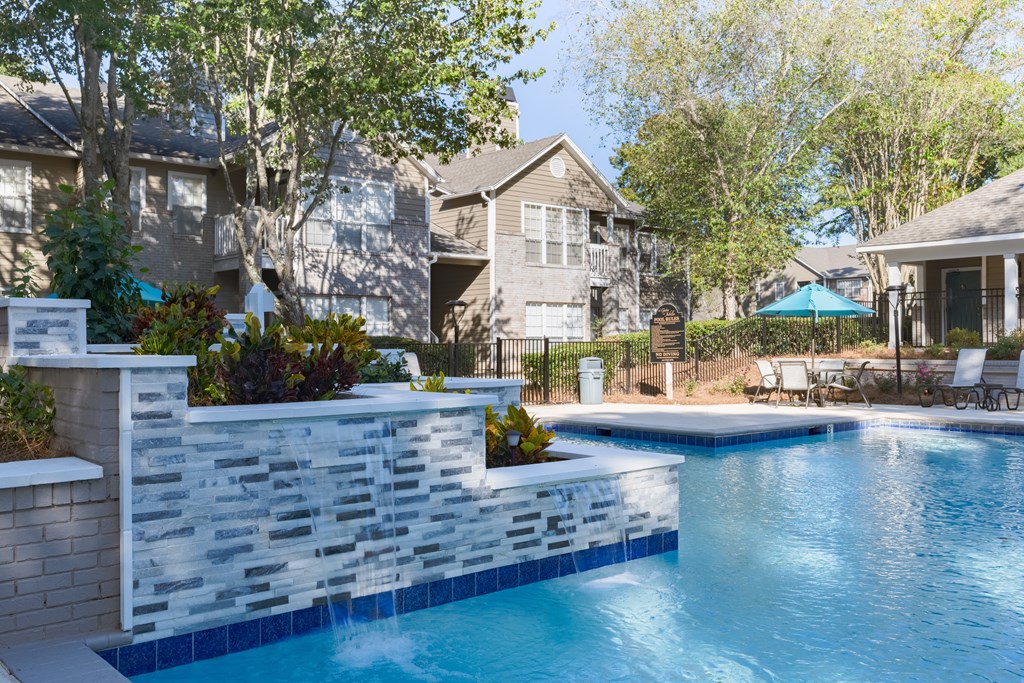 a swimming pool with a house in the background
