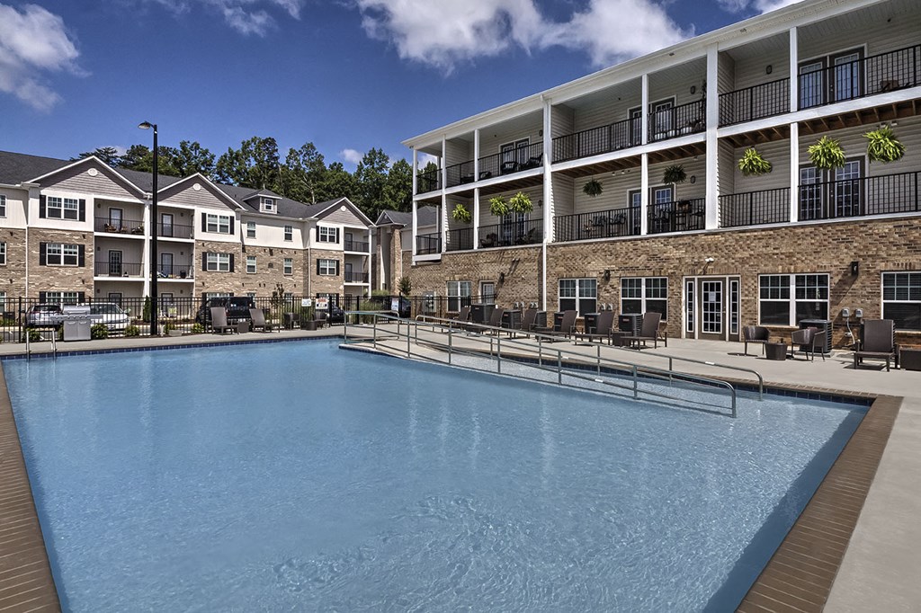 Outdoor pool with lounge chairs at Retreat at the Park apartments for rent in Burlington, NC