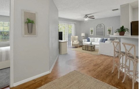 A living room with a white couch and a rug on the floor.