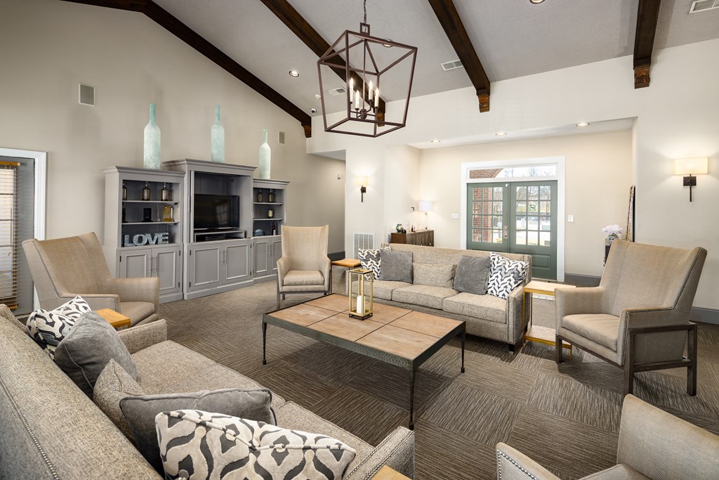 Leasing office and resident clubhouse interior with seating areas at The Oaks of St. Clair in Moody, AL