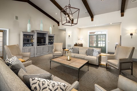 Leasing office and resident clubhouse interior with seating areas at The Oaks of St. Clair in Moody, AL