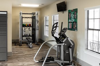 Fitness center with cardio and strength equipment at The Oaks of St. Clair in Moody, AL - Photo Gallery 8