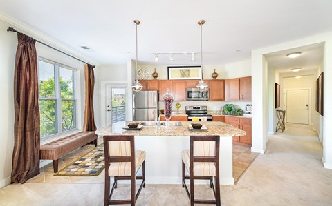 a kitchen with a marble counter top and a kitchen island