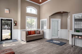 Interior of the leasing center with comfortable seating at Renaissance at Galleria in Hoover, AL - Photo Gallery 4