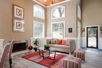 Leasing office and resident clubhouse with seating and fireplace at Renaissance at Galleria in Hoover, AL - Photo Gallery 3