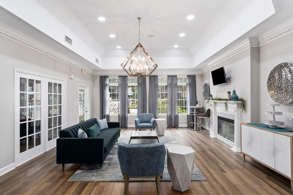a living room filled with furniture and a large chandelier