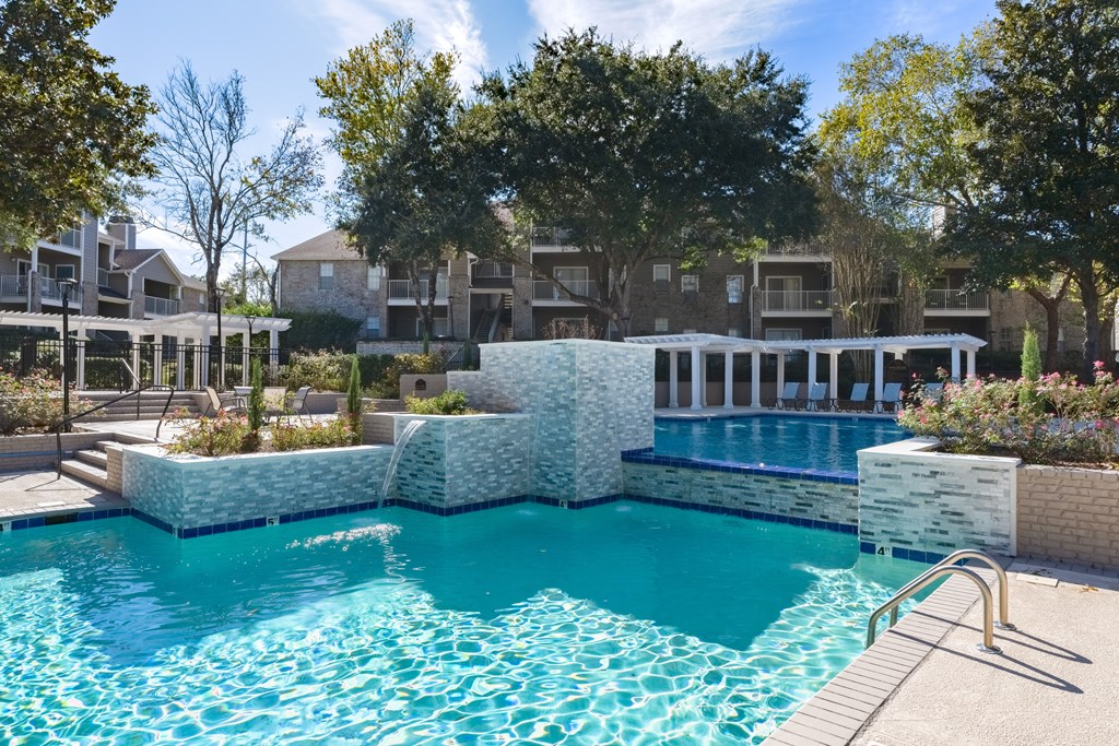 a swimming pool with an apartment building in the background